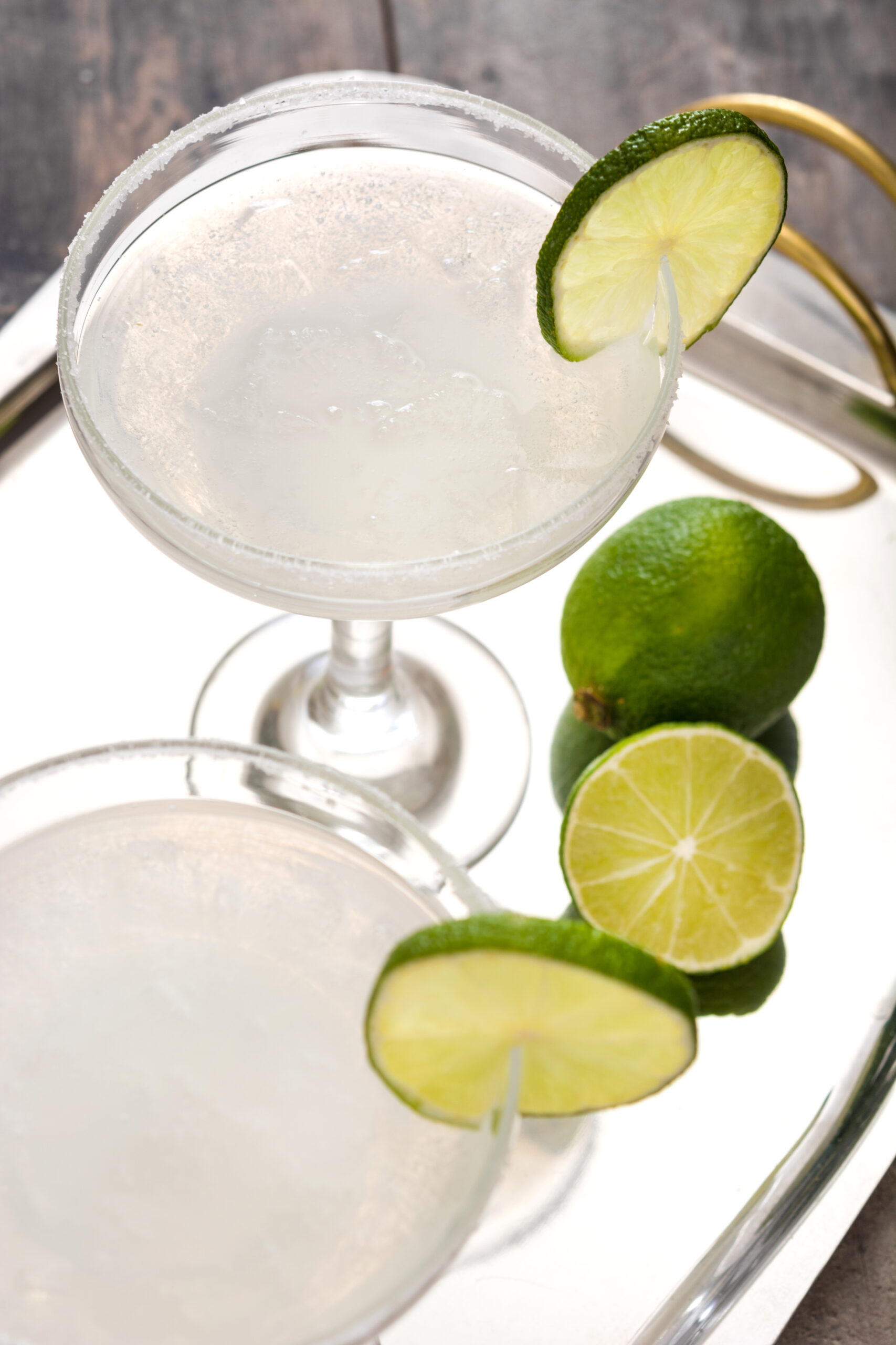 two margarita cocktails garnished with limes on tr 2026 01 09 12 00 21 utc
