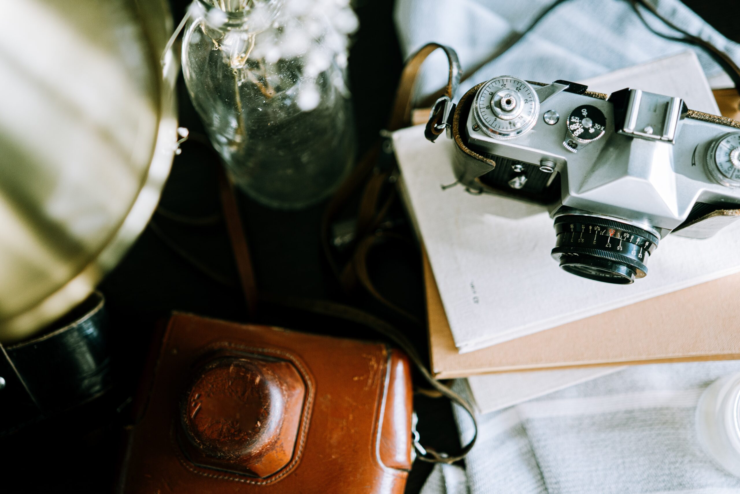 vintage camera still life with glass vase 2026 03 09 21 49 53 utc